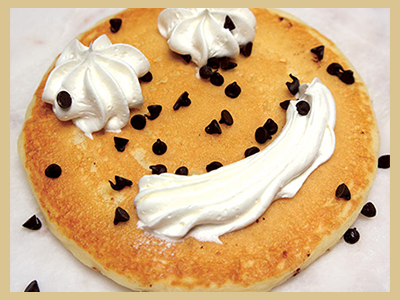 One pancake with chips and whipped cream